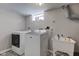 Laundry room with a washing machine, dryer, and utility sink at 5937 Guilford Ave, Indianapolis, IN 46220