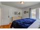Well-lit bedroom featuring hardwood floors and a comfortable bed at 5937 Guilford Ave, Indianapolis, IN 46220