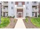 Inviting condo building entrance with decorative landscaping and a well-lit walkway at 6231 Amber Creek Ln # 312, Indianapolis, IN 46237