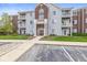 Multi-story condo building featuring balconies, attractive siding, and landscaped surroundings at 6231 Amber Creek Ln # 312, Indianapolis, IN 46237