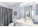 Bathroom showcasing a single vanity with a large mirror and a shower with a curtain at 6231 Amber Creek Ln, Indianapolis, IN 46237