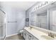Bright bathroom featuring a double vanity, large mirror, and a glass-enclosed shower at 6231 Amber Creek Ln, Indianapolis, IN 46237