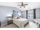 A cozy bedroom with a large window, ceiling fan, and stylish decor at 6231 Amber Creek Ln, Indianapolis, IN 46237