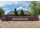 Attractive community entrance with brick pillars, manicured landscaping and easy-to-read signage at 6231 Amber Creek Ln, Indianapolis, IN 46237