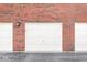 View of the garage doors on a modern townhome, offering convenient parking and storage space at 6231 Amber Creek Ln, Indianapolis, IN 46237
