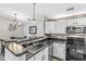 Modern kitchen with a breakfast bar, stainless steel appliances, and stylish pendant lighting at 6231 Amber Creek Ln, Indianapolis, IN 46237