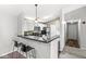 Bright kitchen featuring white cabinets, black countertops, and bar seating at 6231 Amber Creek Ln, Indianapolis, IN 46237