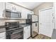 Bright kitchen with white cabinets, stainless steel appliances, and updated countertops at 6231 Amber Creek Ln, Indianapolis, IN 46237