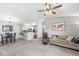Bright, open-concept living room featuring gray carpet and walls, ceiling fan, and modern furnishings at 6231 Amber Creek Ln, Indianapolis, IN 46237