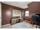 Bedroom with round rug, wood entertainment center with map, and natural light at 6611 Valley Mills Ave, Indianapolis, IN 46241