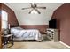 Bedroom featuring a ceiling fan, modern TV, neutral carpet, and half painted accent wall at 6611 Valley Mills Ave, Indianapolis, IN 46241