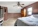 Cozy bedroom with a window, carpet, dark accent wall, and a wooden armoire at 6611 Valley Mills Ave, Indianapolis, IN 46241