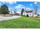 Exterior view of white home with large lot, grass lawn, and established trees at 6611 Valley Mills Ave, Indianapolis, IN 46241