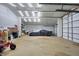 Interior view of garage with storage and lighting, plus a covered car at 6611 Valley Mills Ave, Indianapolis, IN 46241