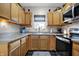 Bright kitchen boasts stainless appliances, a view to the backyard, and wood cabinets at 6611 Valley Mills Ave, Indianapolis, IN 46241