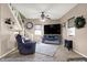 Comfortable living room with ceiling fan, cozy seating, and open staircase creates an inviting and relaxed atmosphere at 6611 Valley Mills Ave, Indianapolis, IN 46241