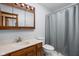 Cozy bathroom with a single sink vanity, a mirrored medicine cabinet, and a shower-tub combo at 6628 Moss Cir, Indianapolis, IN 46237