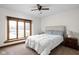 Comfortable bedroom with a large window, plush carpet, and a cozy queen-size bed at 6628 Moss Cir, Indianapolis, IN 46237
