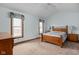 Bright bedroom featuring a cozy bed, two windows with valances, and neutral colored carpet at 6628 Moss Cir, Indianapolis, IN 46237