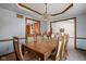 Formal dining room with decorative ceiling, wooden accents, and views into living room at 6628 Moss Cir, Indianapolis, IN 46237
