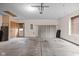 Spacious garage with ample storage cabinets and a work area, and a roll-up door at 6628 Moss Cir, Indianapolis, IN 46237