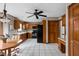 Functional kitchen with black appliances, wooden cabinets, and a ceiling fan at 6628 Moss Cir, Indianapolis, IN 46237