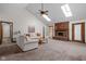Spacious living room with vaulted ceilings, skylights, a brick fireplace, and neutral decor at 6628 Moss Cir, Indianapolis, IN 46237