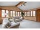 Bright sun room with beamed ceiling, large windows, and comfortable seating area at 6628 Moss Cir, Indianapolis, IN 46237
