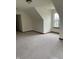 Attic space features neutral walls, carpeting, and a window overlooking the yard at 6816 Russett Dr, Plainfield, IN 46168