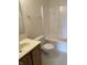 Standard bathroom with a vanity, toilet, mirror, and shower over tub at 6816 Russett Dr, Plainfield, IN 46168