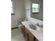 Well-lit bathroom with a large mirror, vanity, and toilet with wall accessories at 6816 Russett Dr, Plainfield, IN 46168