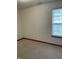 Simple bedroom featuring clean neutral walls and a window with a decorative blind at 6816 Russett Dr, Plainfield, IN 46168