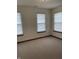 Bedroom featuring neutral carpet and two windows with decorative shades at 6816 Russett Dr, Plainfield, IN 46168