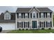 Charming two-story home with gray siding, black shutters, well-maintained lawn, and a two-car garage at 6816 Russett Dr, Plainfield, IN 46168