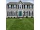Attractive exterior with a lush lawn, contrasting shutters, and a vibrant green front door at 6816 Russett Dr, Plainfield, IN 46168