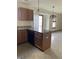 An open kitchen features an island with granite countertops and bright, natural lighting at 6816 Russett Dr, Plainfield, IN 46168