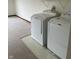 Bright laundry room features a standard washer and dryer, and tiled flooring at 6816 Russett Dr, Plainfield, IN 46168