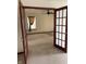 Living room featuring neutral carpet, a ceiling fan, and french doors at 6816 Russett Dr, Plainfield, IN 46168