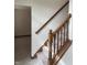 Classic staircase with carpeted steps and stained wood banister leading to the upper level at 6816 Russett Dr, Plainfield, IN 46168
