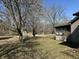 Expansive backyard with large trees, storage shed and partial view of the house at 7164 Sandalwood Dr, Avon, IN 46123