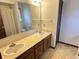 Bathroom featuring double vanity with wooden cabinets and large mirror at 7164 Sandalwood Dr, Avon, IN 46123