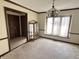 Traditional dining room featuring neutral walls, plush carpeting, chandelier, and large window at 7164 Sandalwood Dr, Avon, IN 46123