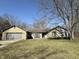 Charming single-story home featuring a stone facade and attached garage, set on a spacious lot with mature trees at 7164 Sandalwood Dr, Avon, IN 46123