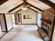 A spacious living room featuring a stone fireplace, vaulted ceilings with exposed beams, and lots of natural light at 7164 Sandalwood Dr, Avon, IN 46123