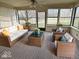 Staged sunroom with stylish wicker furniture, creating a relaxing and inviting space at 7164 Sandalwood Dr, Avon, IN 46123