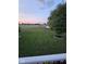 A well-maintained lawn is lined with young trees and a pond at 7254 Cambridge Pl, Avon, IN 46123
