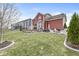 Spacious backyard features a deck, fire pit with Adirondack chairs, and a well-maintained lawn at 7254 Cambridge Pl, Avon, IN 46123