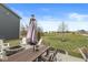 A backyard features a fire pit and outdoor dining set with umbrella at 7254 Cambridge Pl, Avon, IN 46123