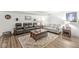 Relaxing basement with plush seating, area rug, and dark wood flooring at 7254 Cambridge Pl, Avon, IN 46123