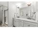 Well-lit bathroom with double sinks, granite countertops, and a glass-enclosed shower, offering comfort and style at 7254 Cambridge Pl, Avon, IN 46123